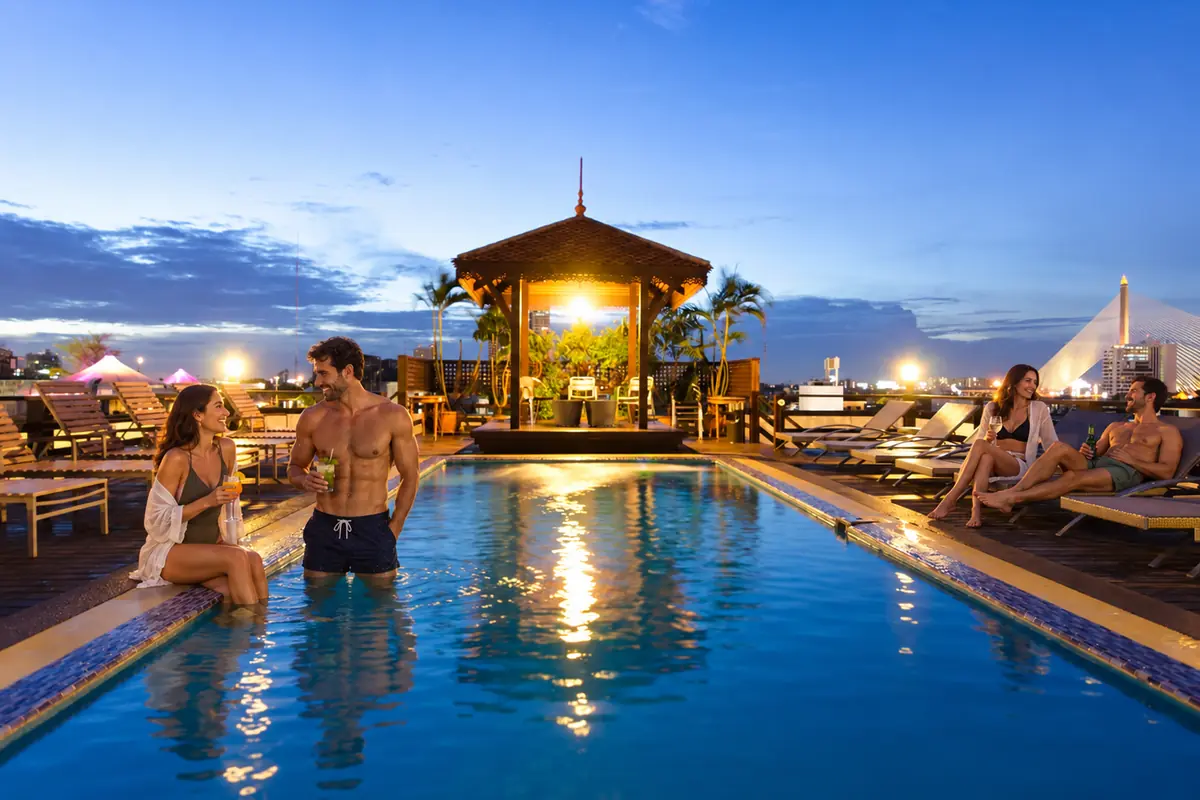 Two adult couples enjoying the real rooftop swimming pool at Khaosan Palace Hotel