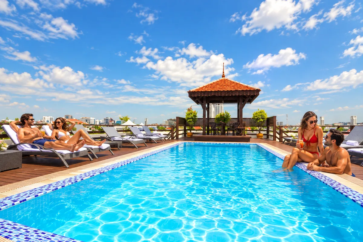 Two couples relaxing by a rooftop pool on Khaosan Road