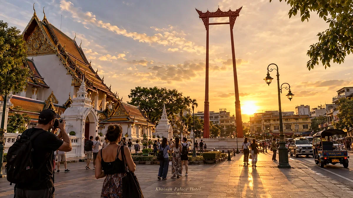Visitors walking near Bangkok’s Giant Swing at golden hour