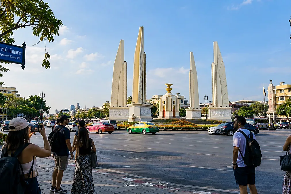 Travelers walking near Democracy Monument in Bangkok Old Town