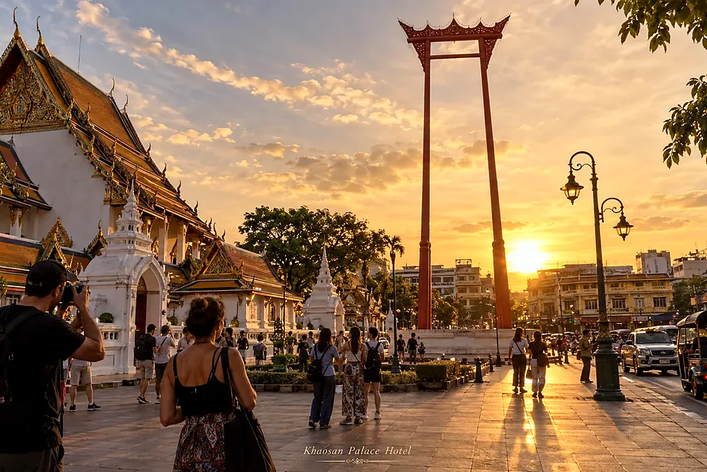 Travelers exploring the Giant Swing and Wat Suthat area in Bangkok Old Town at golden hour